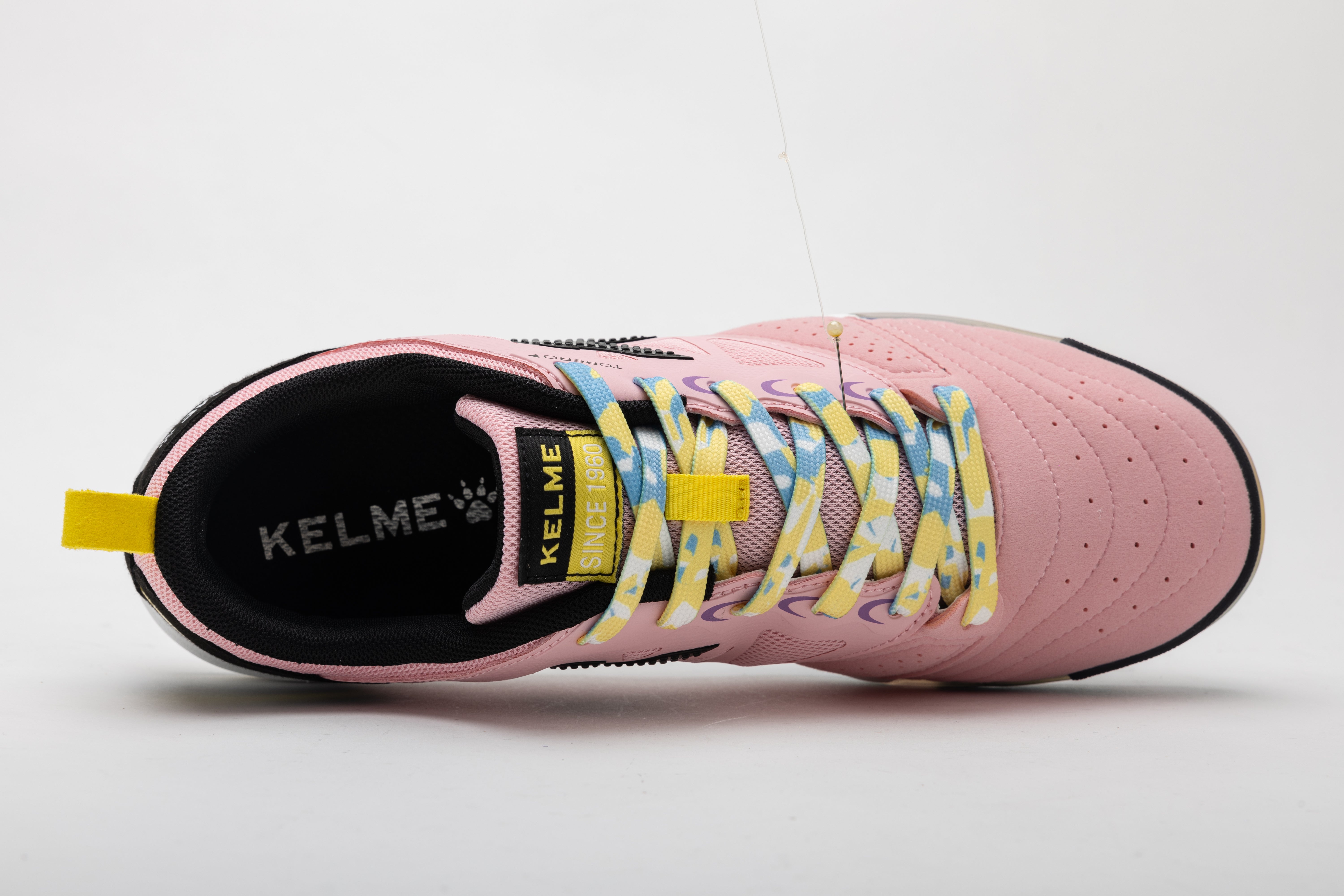 Kelme men's futsal shoes in pink with black lining, lace-up