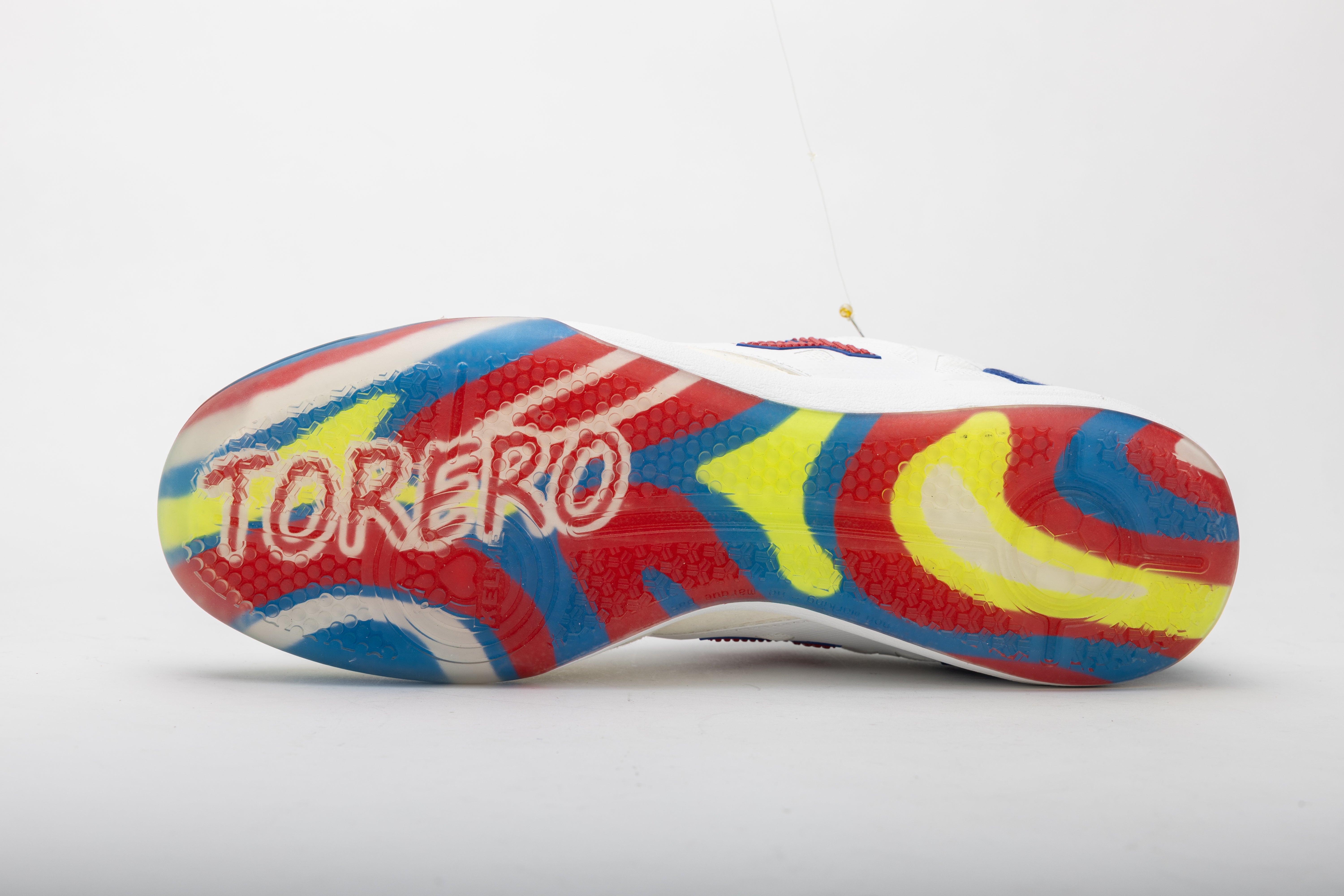 Men's futsal shoes by Kelme, colorful outsole with “TOREBRO” graphic
